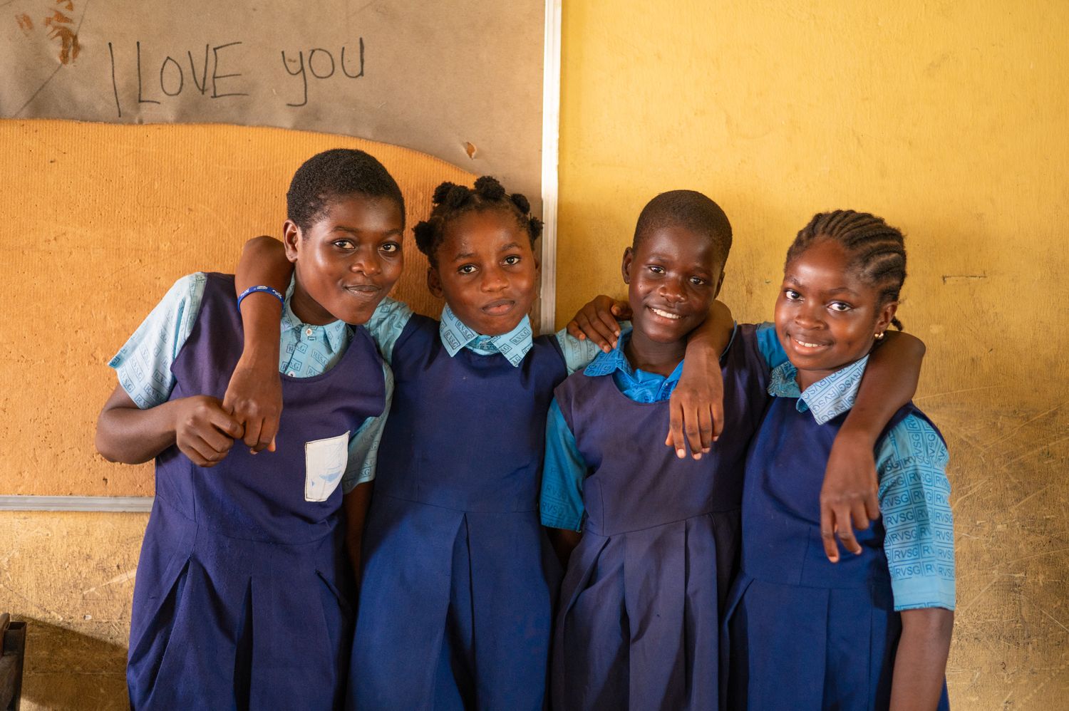 Four pupils in school uniform in their classroom in Rivers State